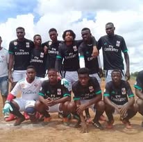 Liberator Football Club team photo showing players and coaching staff in team jerseys